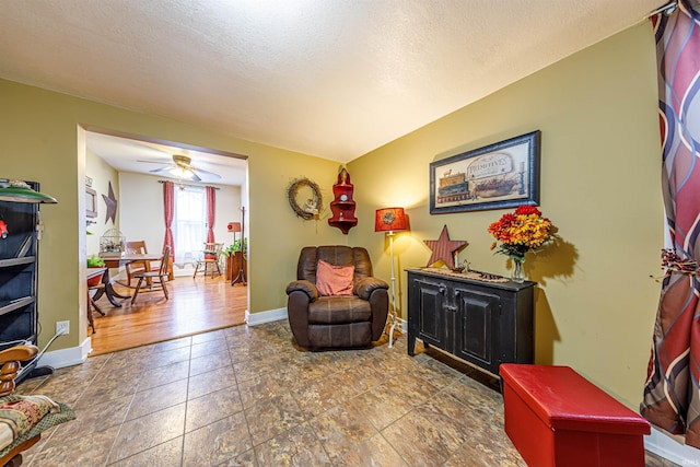 sitting room featuring ceiling fan, hardwood / wood-style floors, and a textured ceiling