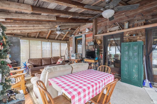 dining area with vaulted ceiling with beams, plenty of natural light, and ceiling fan