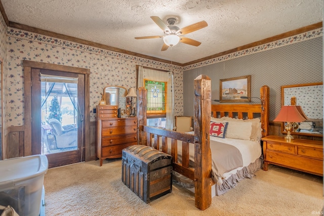 bedroom with ceiling fan, carpet floors, and a textured ceiling