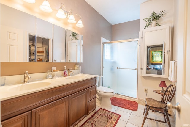 bathroom featuring tile patterned floors, a shower with door, vanity, and toilet