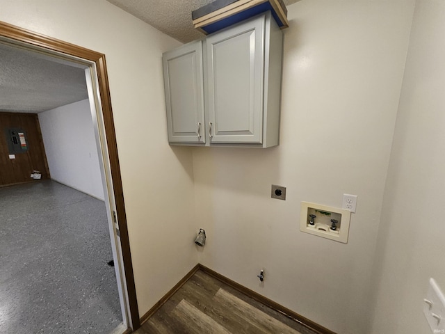 clothes washing area with cabinets, hookup for an electric dryer, dark hardwood / wood-style floors, hookup for a washing machine, and a textured ceiling