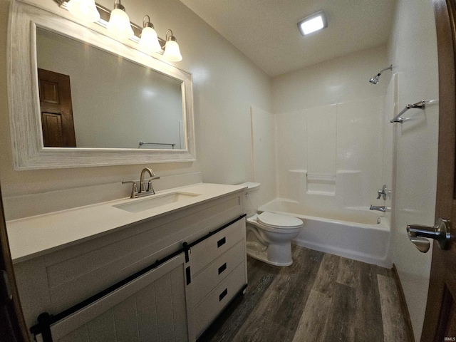 full bathroom featuring shower / washtub combination, hardwood / wood-style floors, vanity, and toilet