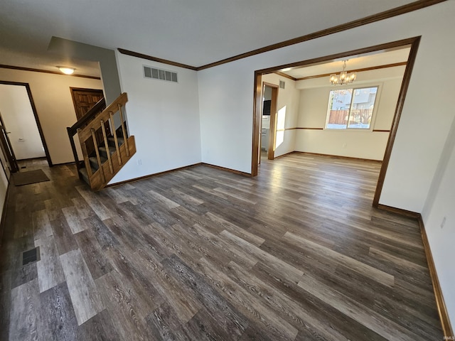 unfurnished living room with dark hardwood / wood-style floors, ornamental molding, and an inviting chandelier