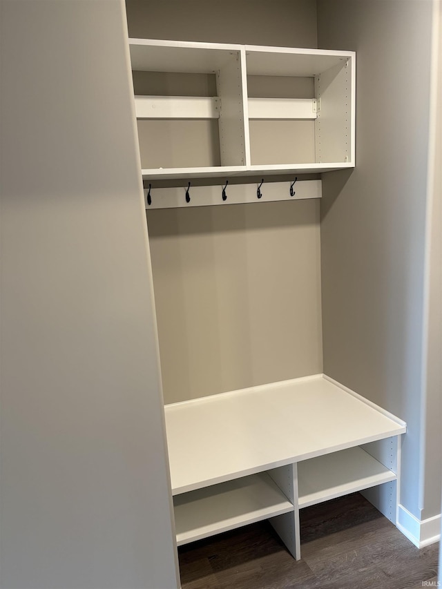 mudroom with baseboards and dark wood-type flooring