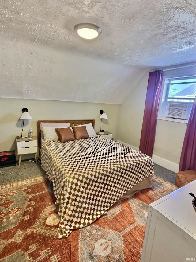 carpeted bedroom with vaulted ceiling and a textured ceiling