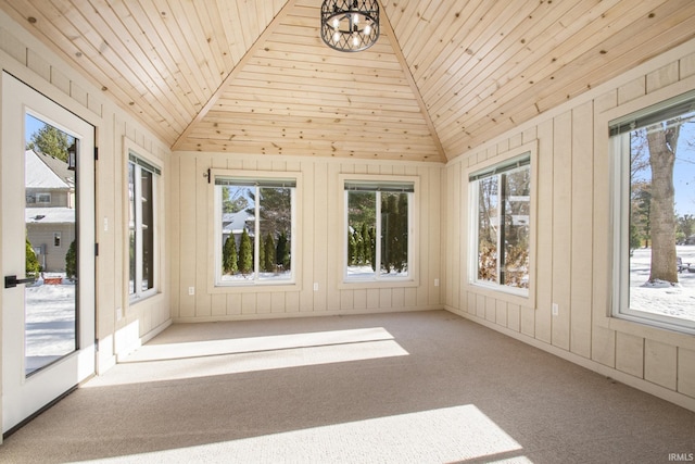 unfurnished sunroom featuring a notable chandelier, wooden ceiling, a wealth of natural light, and vaulted ceiling