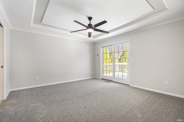 spare room with ceiling fan, a raised ceiling, carpet floors, and crown molding