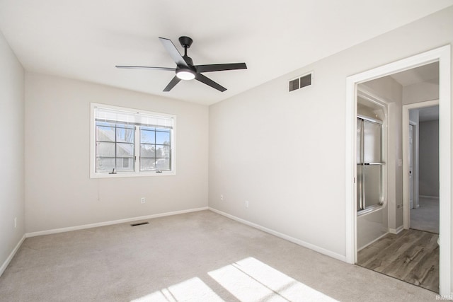 empty room with light carpet and ceiling fan