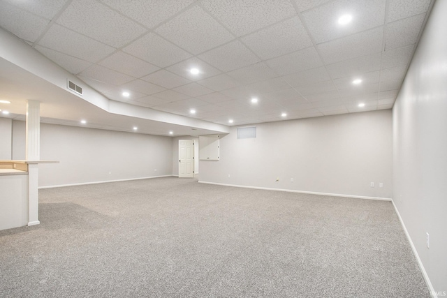 basement with carpet floors and a drop ceiling