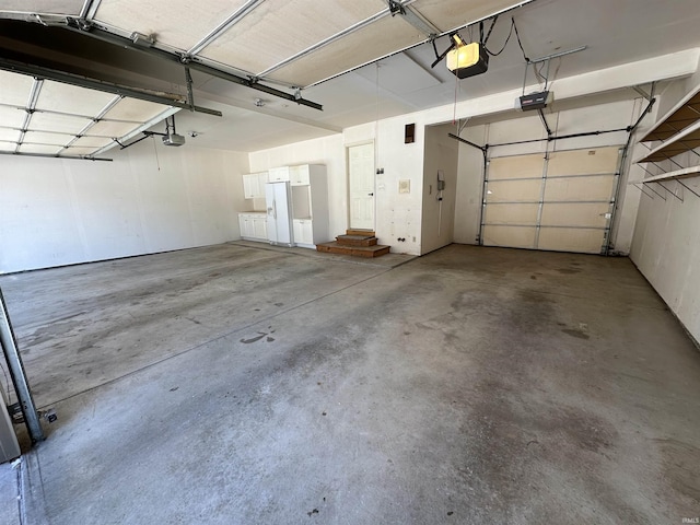 garage with white fridge with ice dispenser and a garage door opener