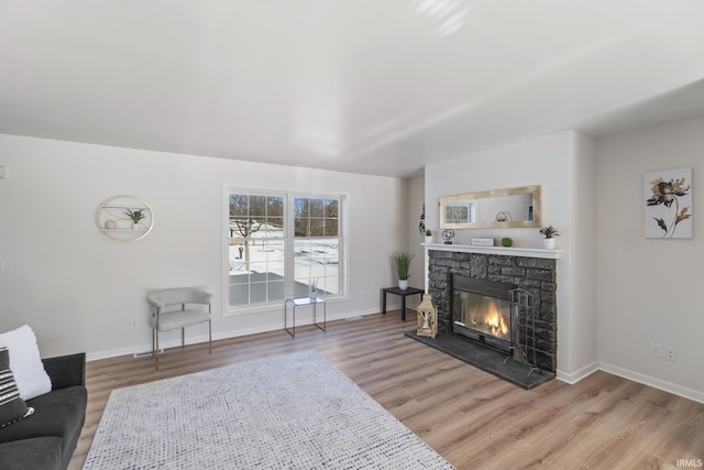 living room with a fireplace and hardwood / wood-style floors