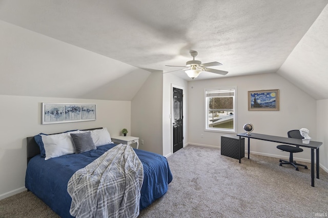 bedroom with carpet flooring, a textured ceiling, vaulted ceiling, and ceiling fan