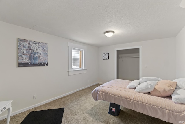 carpeted bedroom with a closet and a textured ceiling