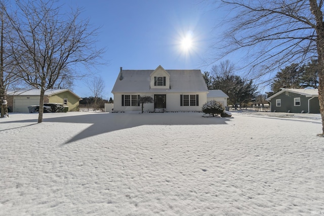 snow covered house with a garage