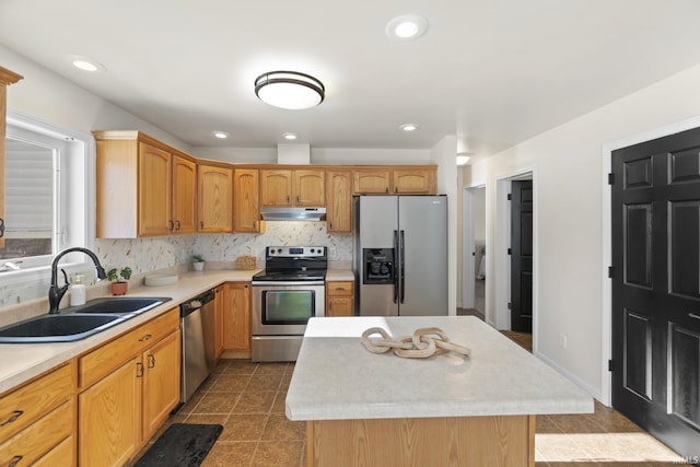 kitchen featuring sink, stainless steel appliances, tile patterned flooring, decorative backsplash, and a kitchen island