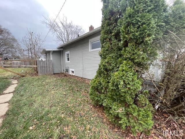 view of side of home featuring a yard