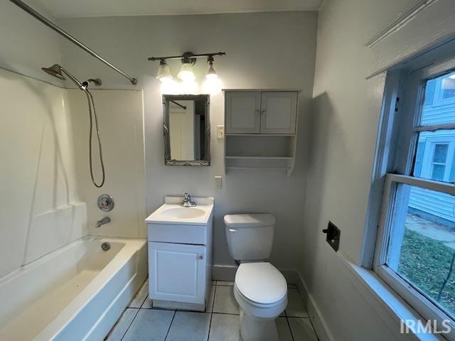 full bathroom with tile patterned floors, vanity, shower / washtub combination, and a wealth of natural light