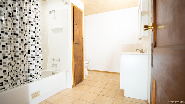 full bathroom with tile patterned flooring, vanity, tiled shower / bath combo, and toilet