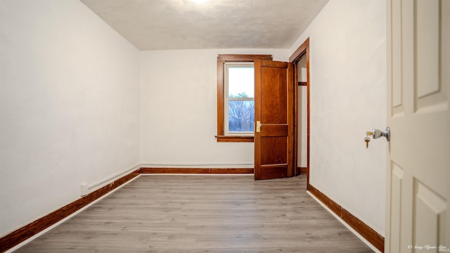 spare room featuring light wood-type flooring