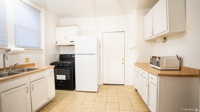 kitchen with white cabinetry, light tile patterned flooring, white appliances, and sink