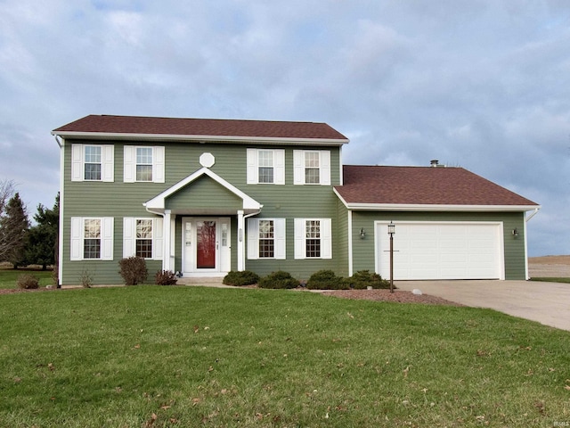 colonial-style house featuring a front yard and a garage