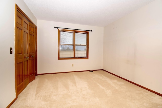 empty room with light colored carpet