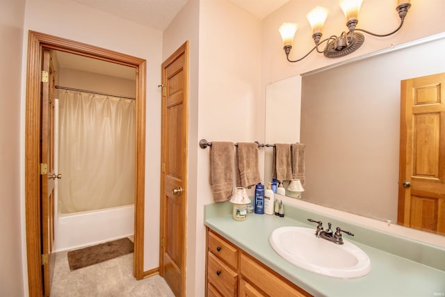 bathroom with vanity, shower / bath combo with shower curtain, and a textured ceiling