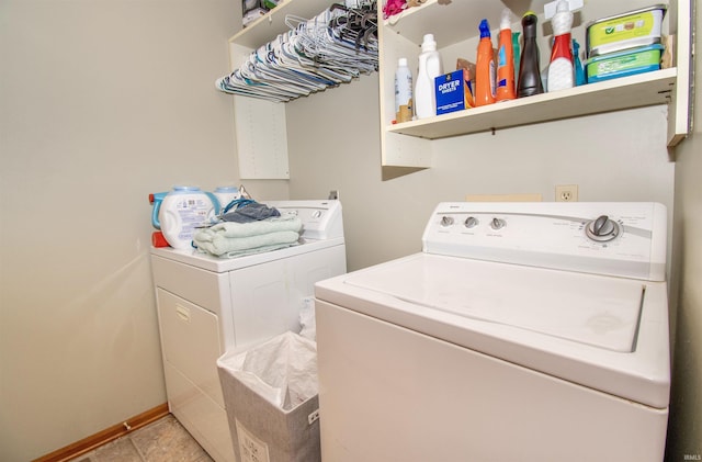 laundry area featuring washer and dryer and light tile patterned floors