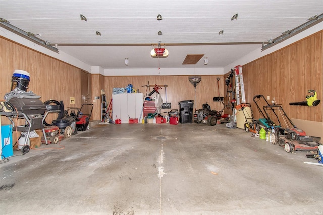 garage with wood walls and a garage door opener