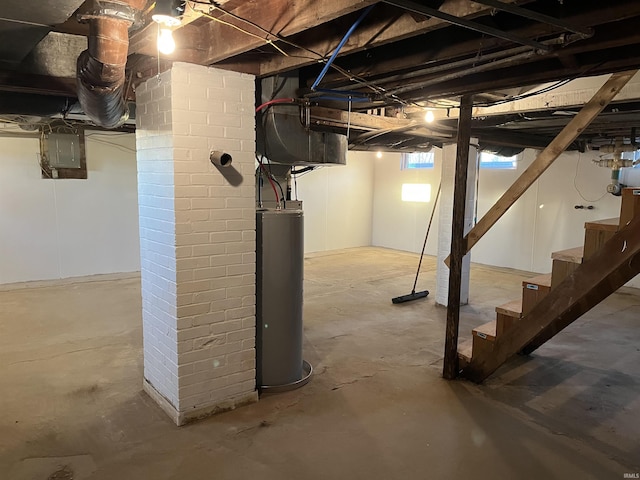 basement featuring electric panel and gas water heater