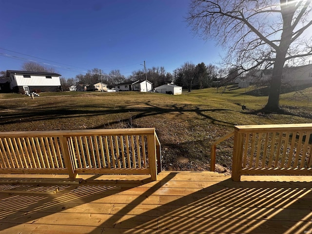 wooden deck featuring a lawn