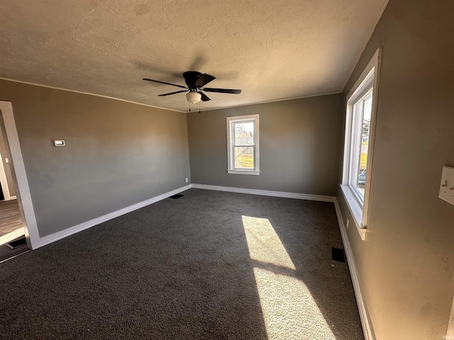 carpeted empty room with a textured ceiling and ceiling fan