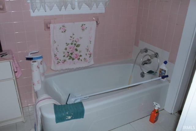 bathroom featuring tile patterned floors and tile walls