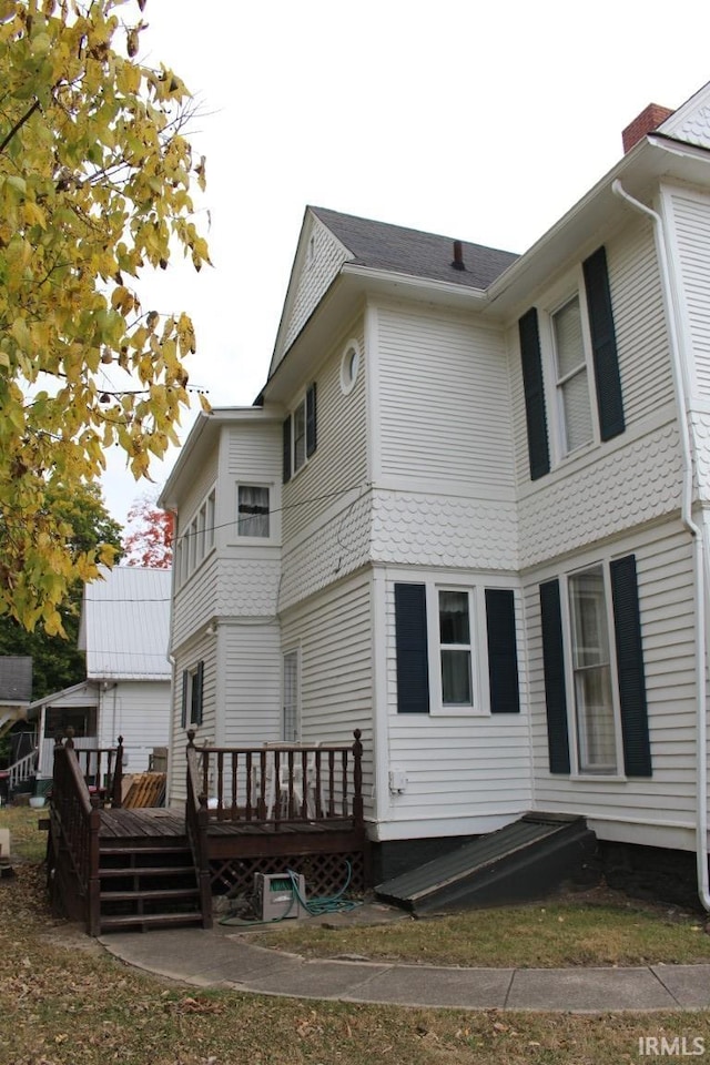 back of property featuring a deck