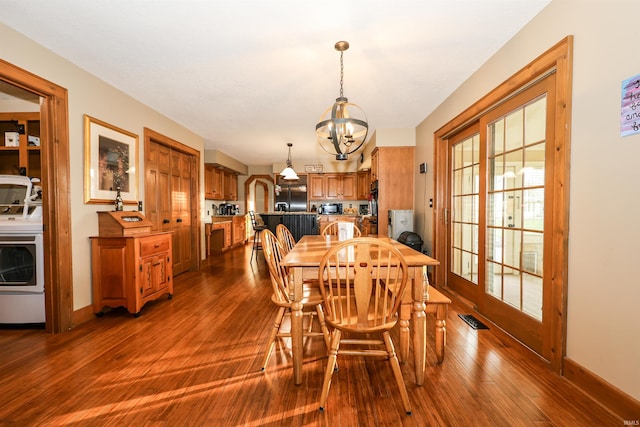 dining room with wood-type flooring and an inviting chandelier