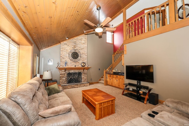 living room featuring a large fireplace, high vaulted ceiling, ceiling fan, and wood ceiling