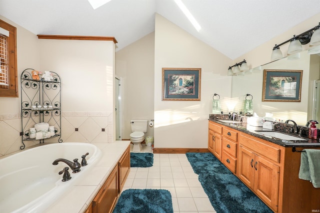 bathroom featuring tile patterned floors, vaulted ceiling, toilet, a bathtub, and vanity