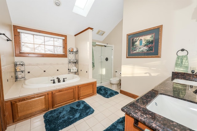 full bathroom with vaulted ceiling with skylight, shower with separate bathtub, toilet, and tile patterned floors