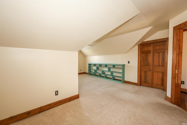 bonus room with carpet flooring and lofted ceiling