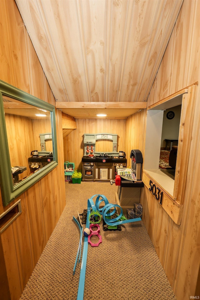 playroom featuring carpet, wood walls, wood ceiling, and vaulted ceiling