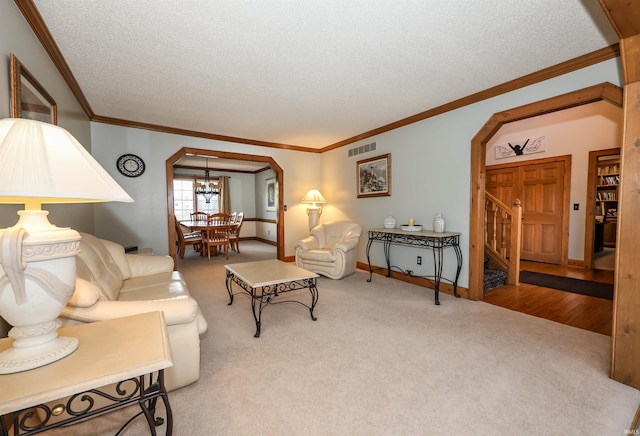 carpeted living room featuring crown molding and a textured ceiling