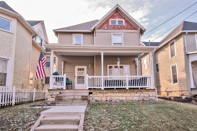 victorian home featuring covered porch and a front yard