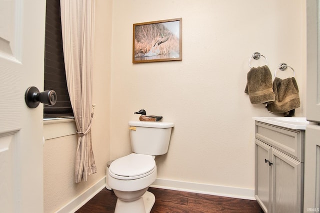 bathroom featuring vanity, hardwood / wood-style flooring, and toilet