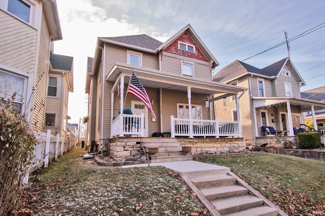 victorian-style house with covered porch and a front lawn