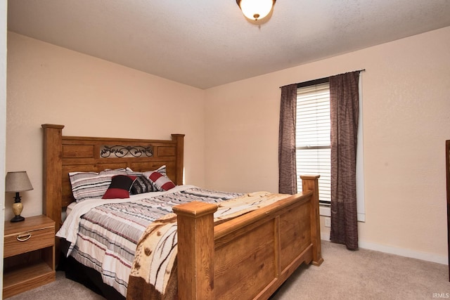 carpeted bedroom with a textured ceiling