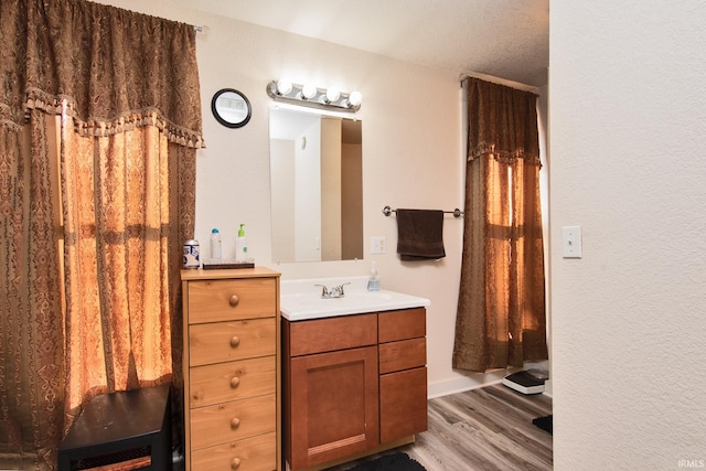 bathroom featuring hardwood / wood-style flooring and vanity