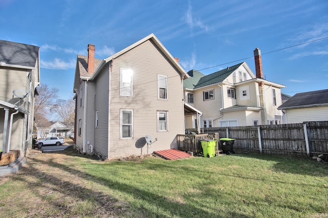 back of property featuring a lawn