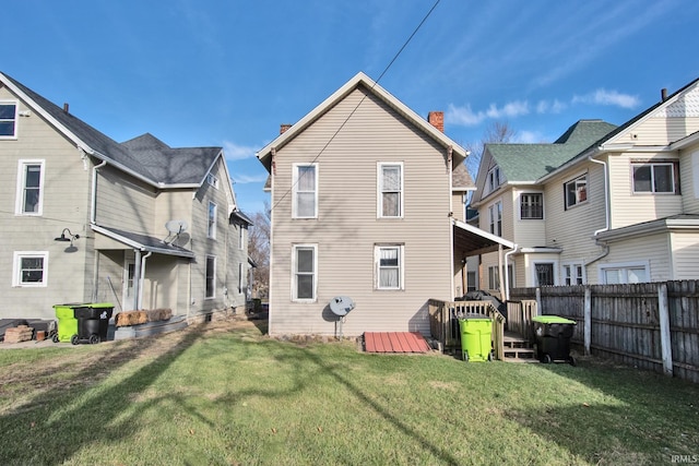 rear view of property featuring a yard