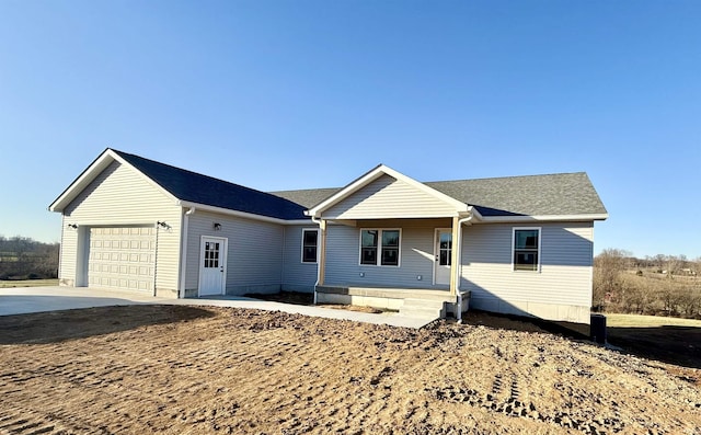 ranch-style home with a garage and covered porch