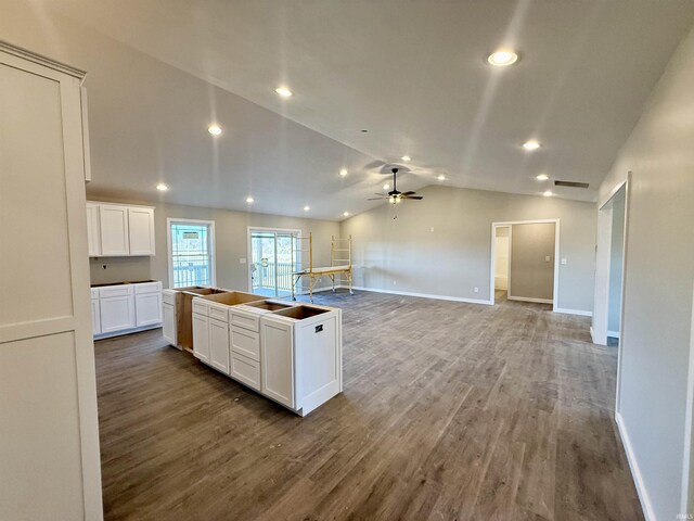 kitchen featuring wood-type flooring, a center island, vaulted ceiling, ceiling fan, and white cabinets